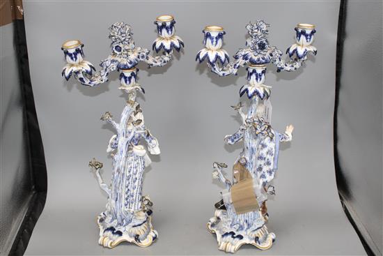 A pair of Meissen porcelain candelabra, modelled with lady and gallant stems, height 46cm